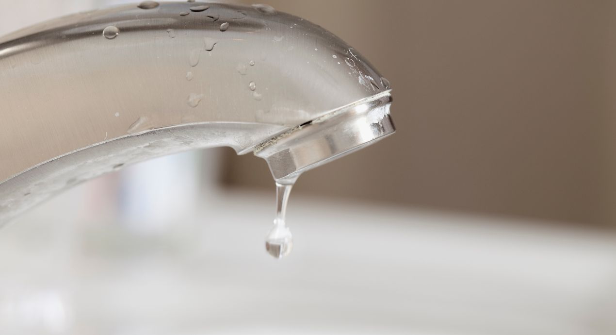 how much water does a dripping faucet waste